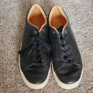 Black leather TOMS sneakers